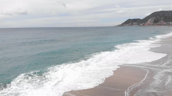 Empty beach and stormy sea waves