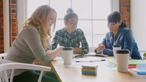 Businesswomen discussing over documents 4k