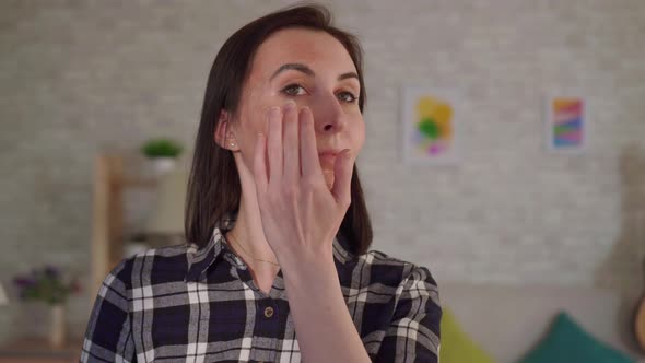 Close Up Young Woman Puts Cream on a Scar From a Burn on Her Face