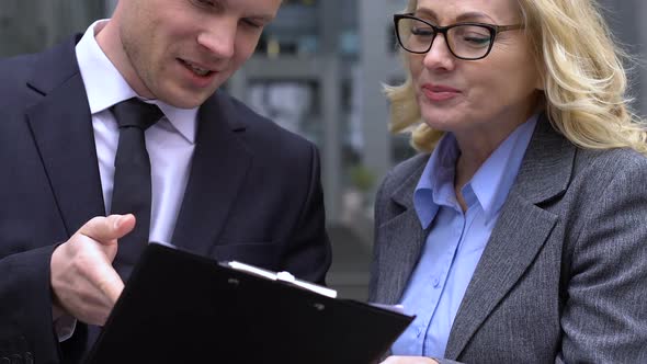 Ambitious Trainee Sharing Business Plan With Elderly Colleague, Work Practice