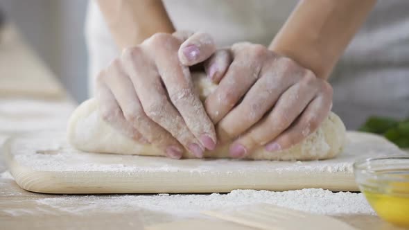 Close-Up Female Hands Kneading Fresh Dough at Home Kitchen, Baking Process