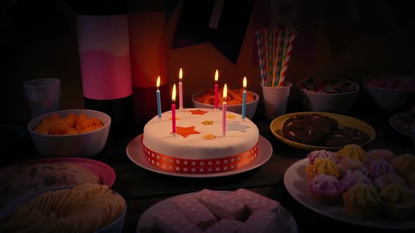 Rotating Around Birthday Cake And Snack Bowls In Dark Room