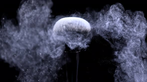 Super Slow Motion Shot of Blue Powder Falling From Facial Brush at 1000Fps