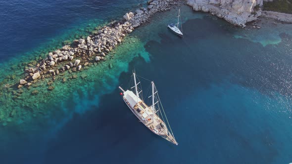 Sailing Yachts Anchored in the Bay with Clear and Turquoise Water