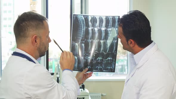 Experienced Doctors Are Studying the X-Ray of Their Patient