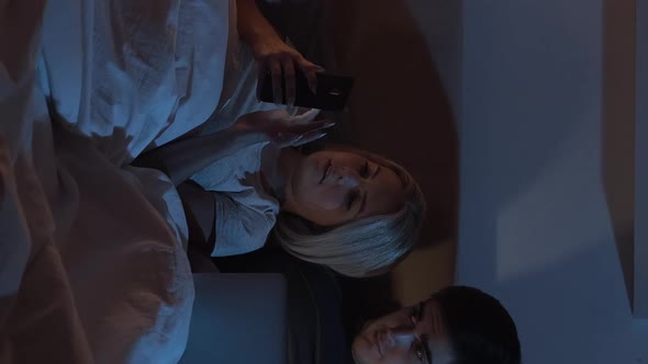 Night Online Couple Using Gadgets in Bed Vertical