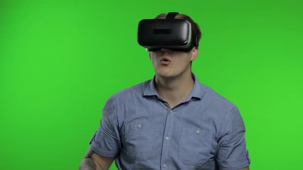 Man Using VR App Helmet To Play Simulation Game, Drawing. Guy Watching Virtual Reality 3d Video