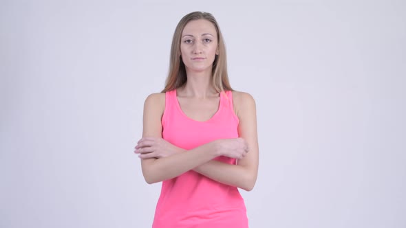 Portrait of Happy Blonde Woman Smiling with Arms Crossed