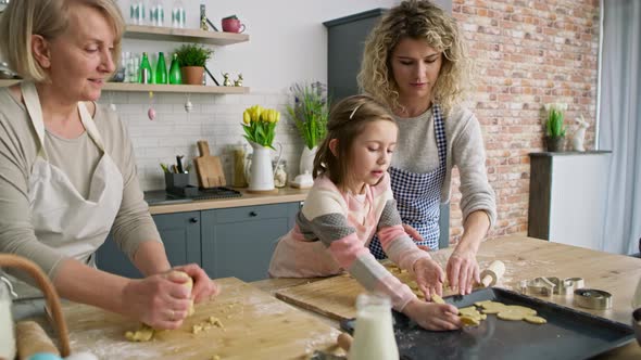 Video of girl with mother and grandma making Easter cookies. Shot with RED helium camera in 8K