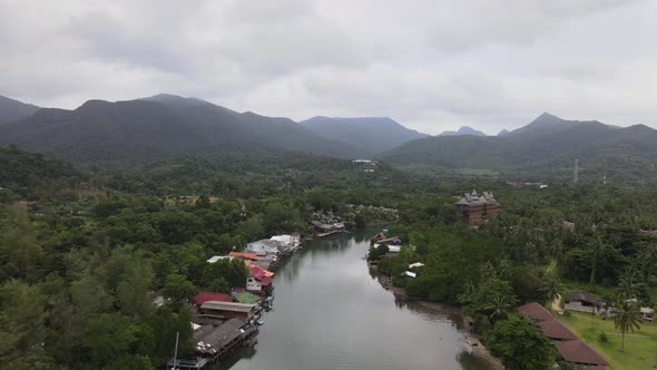Aerial view of river and mountainous scenery, backwards reveal shot
