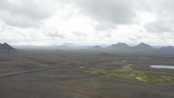 White Clouds In The Sky Over The Mountains And Volcanic Land In Iceland. - aerial