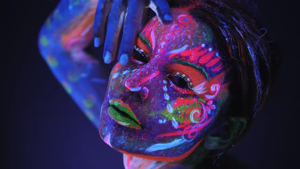 Girl Model Posing with UV Pattern on Body. Body Art Glowing in Ultraviolet Light