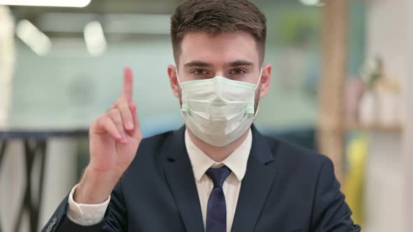 Young Businessman with Protective Face Mask Showing No Sign 