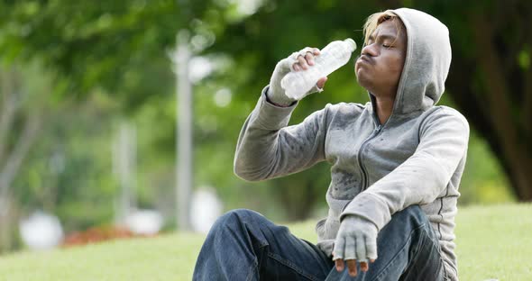 Homeless man drinking water