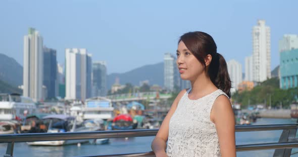 Tourist woman enjoy the view of Hong Kong city with seaside