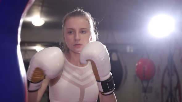 A Woman Boxer Trains Punches a Training Day in the Boxing Hall a Woman Quickly Beats a Series