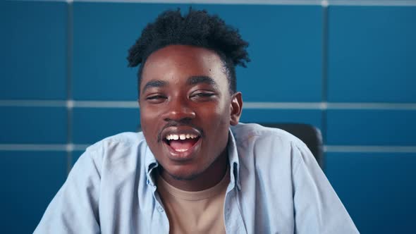 Webcam View of Happy African American Man Talking at Camera From Home Office