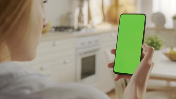 Back View of Woman at Phone with Green Screen for Copy Space