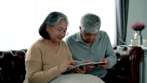 Elderly Asian Using Modern Gadgets