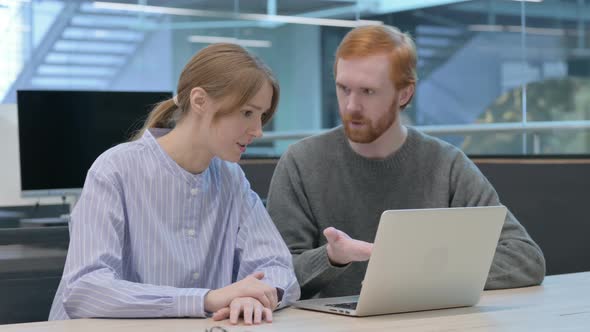 Young Man and Woman Working on Laptop