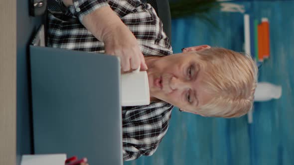 Vertical Video Old Middle Aged Businesswoman Working at Laptop From Home