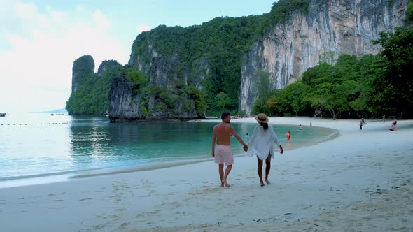 Couple Men and Woman on the Beach of Koh Hong Island Krabi Thailand Asian Woman and European Men on