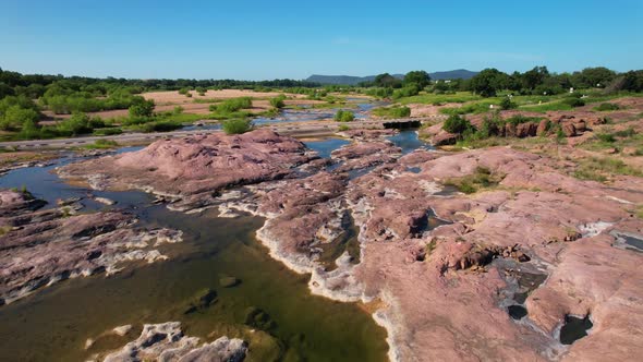 Aerial footage of the popular area on the Llano River in Texas called The Slab.  Camera is moving sl