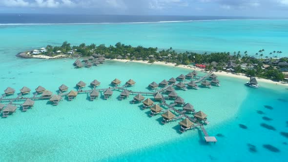 Aerial drone view of a luxury resort and overwater bungalows in Bora Bora tropical island