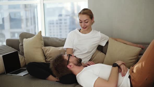 Couple Relaxing on Sofa Together Enjoying Their Relationships and Have a Talk