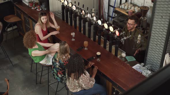 Slow motion shot of women talking and sitting at bar