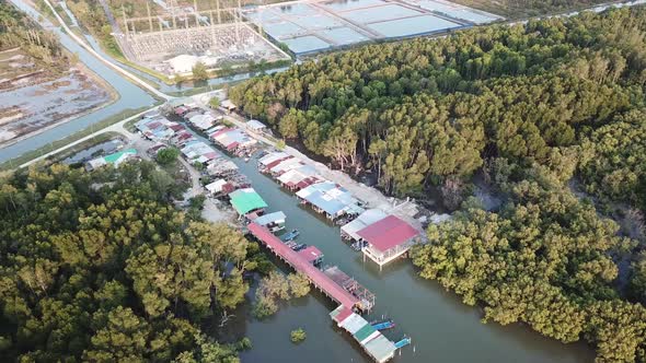 Aerial view a fishing village beside mangrove 