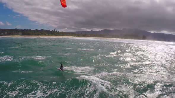 Aerial view of a man kitesurfing in Hawaii