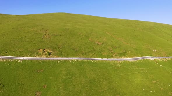 Motorcyclist driving his motorbike on the mountain road in the country side.