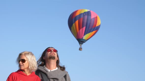 A Middleaged Man and Woman in the Sky with an Air Balloon