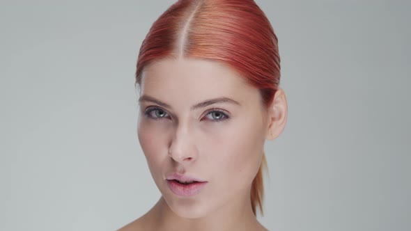 Studio portrait of young, beautiful and natural redhead woman. Beauty concept.