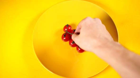 Ripe Fresh Juicy Organic Cherry Tomatoes on a Yellow Plate. Red Cherry Tomatoes in Yellow Textured