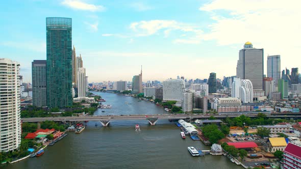 4K : Drones fly over the Chao Phraya River, buildings and business districts in Bangkok