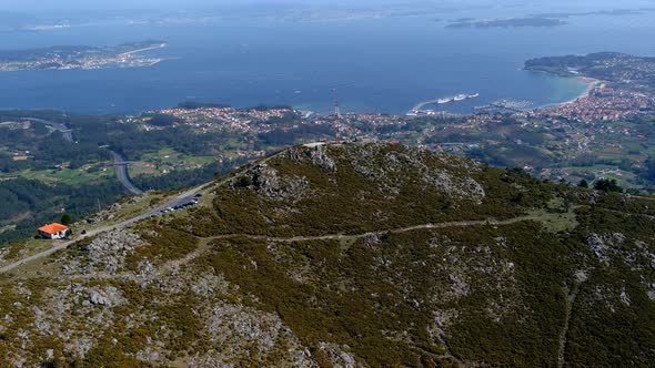 Aerial View Over Miradoiro da Curota Landscape With Radio Mast On Hilltop And Ría de Arousa In Backg