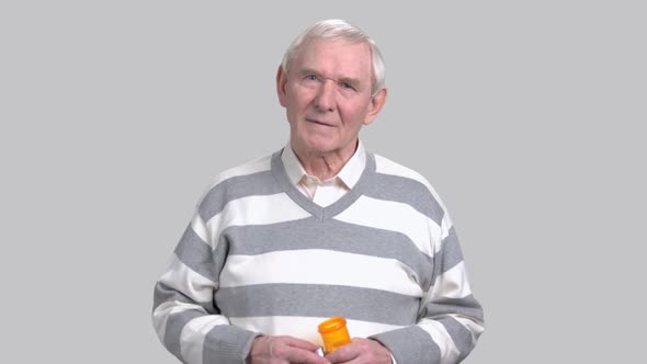 Senior Man with Medicine Bottle.