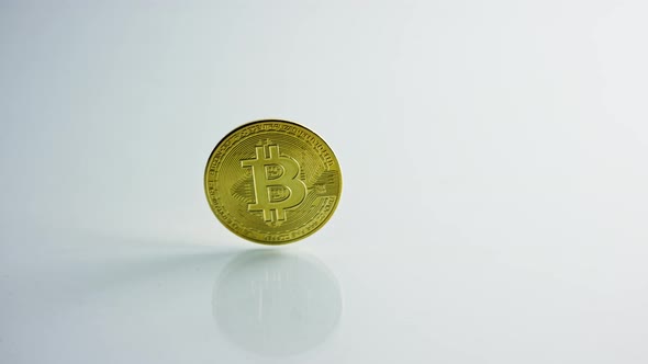Golden Bitcoin and Dollars on White Background