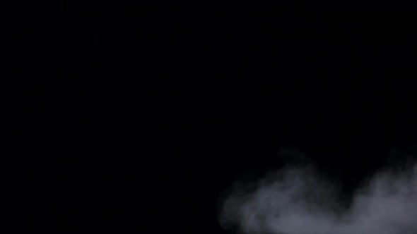 White Haze Swirls on Isolated Black Studio Background, Slow Motion alt