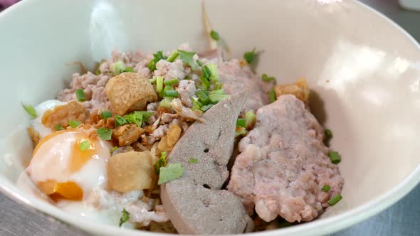 Close-up Footage of Thai Styled Egg Noodles With Minced Pork Cake and Pork Liver, Thailand Popular S