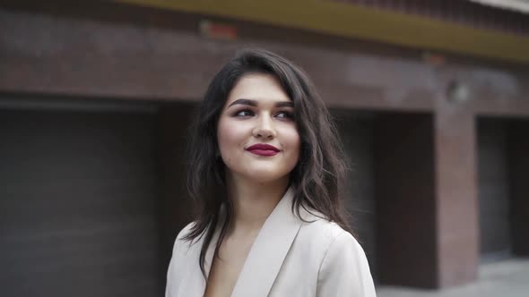 Portrait of Admiring Brunette with Cute Smile Looking at the Sky During a Walk