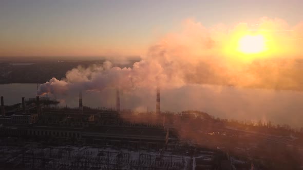 Industrial Zone with a Large Red and White Pipe Thick White Smoke Is Poured From the Factory Pipe in