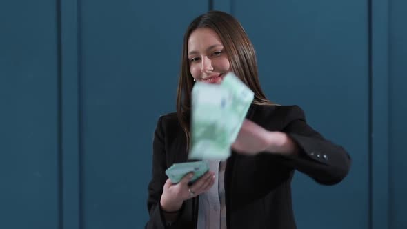 Young Happy Businesswoman Dancing and Throwing Money. Slow Motion. Successful Business or Winning