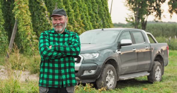 The Friendly Owner of the Plantation Stands in the Field with Hops Crosses His Arms