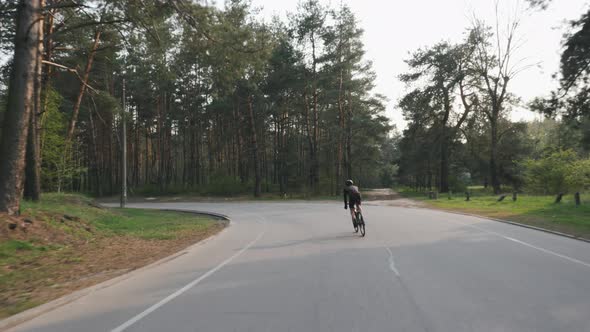 Cyclist riding alone in the park while training for race