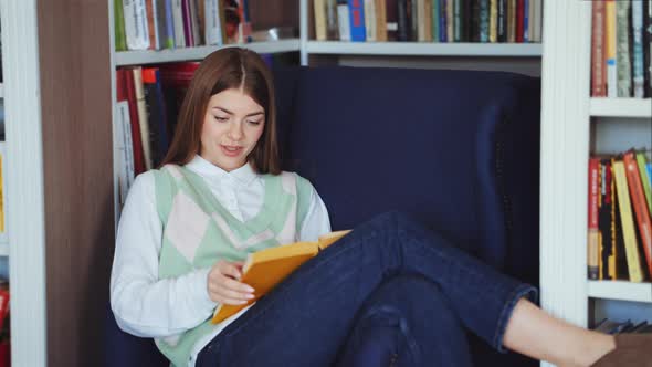 Woman reading bestseller book in library