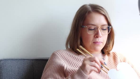 Woman having a meal in living room