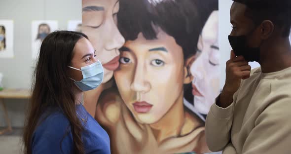 Multiracial students painting inside art room class at college